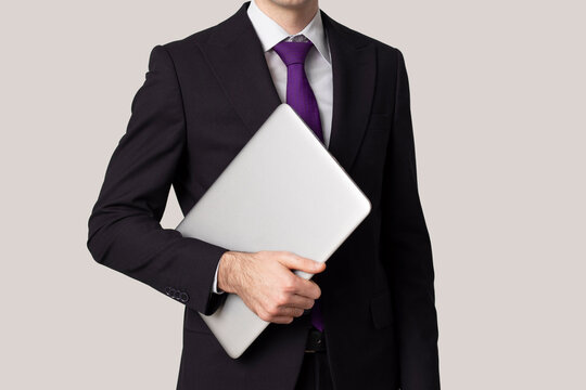 Frame image of a businessman with laptop, on grey background.  Copy space.