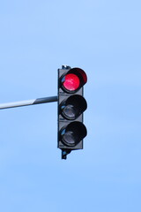 Stop red light on traffic lights. Isolated on blue background. Negative copy space. Sunny day.