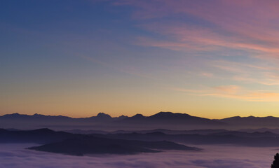 Fototapeta na wymiar Le valli tra monti si riempiono al tramonto di un mare di nuvole