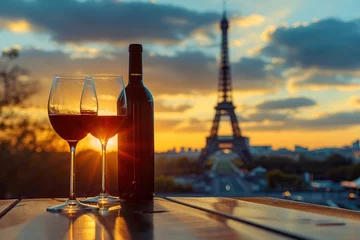 Papier Peint photo Paris Bottle and wineglasses on table on Eiffel Tower background