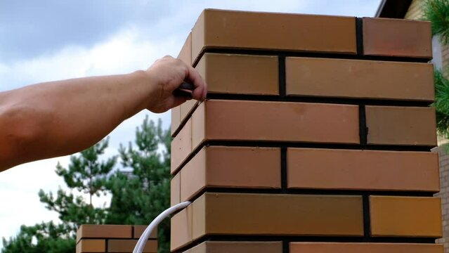 Builder removes cement residues on masonry