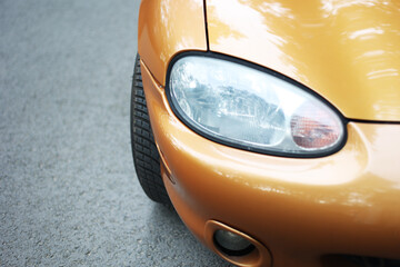 Car headlight close up on the street