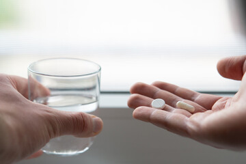 close up of hands holding pill and glass of water. Medicine pharmacy health. close up of a man...