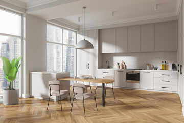 Luxury home kitchen interior with cooking cabinet and eating table near window