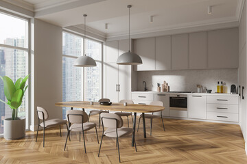 Stylish home kitchen interior with dining table and cabinet, panoramic window