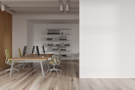 Stylish coworking interior with pc computers, shelf with documents. Mockup wall