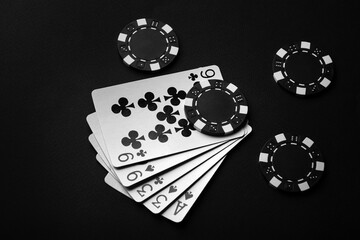 Chips and black playing cards with a winning combination of high card. The concept of luck or...