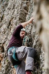 Experienced climber rock climbing outdoors in the nature
