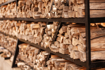 firewood is stacked on a stand