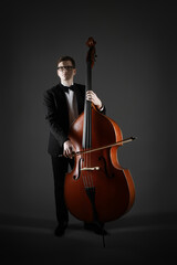 Double bass player playing contrabass. Classical musician bassist