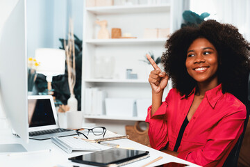 African woman smiling on happy face, looking on screen with valued achievement at high profit with newest company project. Concept of cheerful expression in work from home lifestyles. Tastemaker.