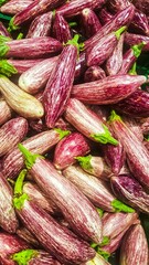 Sardinia, Italy - April 03, 2016 : A close up of a pile of fresh egg plant on the market. This variety is red purple with white.