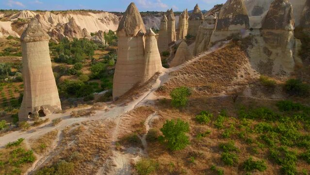 Through this drone footage embark on a journey to the enchanting Goreme National Park in Cappadocia, Turkey. Marvel at the surreal rock formations that characterize this unique landscape. These unique