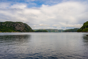 Fototapeta premium Steep mountains framing Lyngdalsfjorden viewed from Farsund.