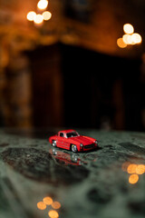 Red Toy Car with Bokeh Lights Background