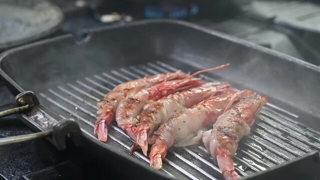 gamberi cotti alla piastra nella cucina di un ristorante