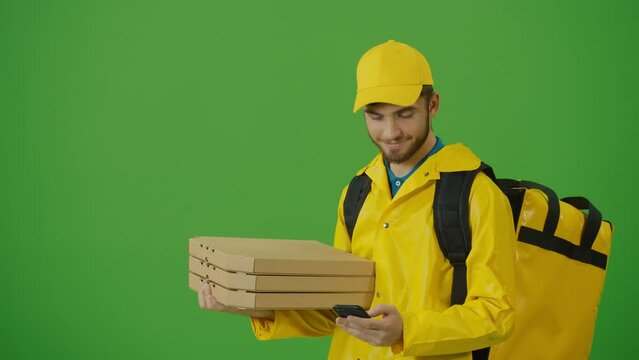 Green Screen Courier On the Way to Deliver Order to Client. Deliveryman Worker Deliver Online Order Client. Delivery Man in Yellow Uniform With Thermal Backpack Brings Pizza Boxes, Coffee