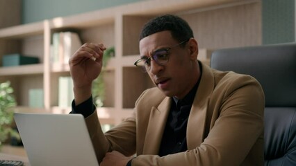 Desperate upset worried African American businessman ceo leader male stressed business man ethnic guy looking at laptop in corporate office sad problem trouble with computer loss project failure error