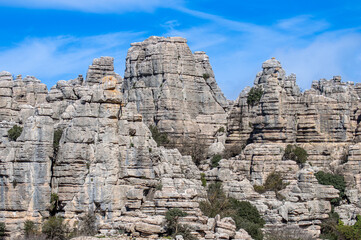 Hiking the Torcal de Antequerra National Park, limestone rock formations and known for unusual karst landforms in Andalusia, Malaga, Spain.