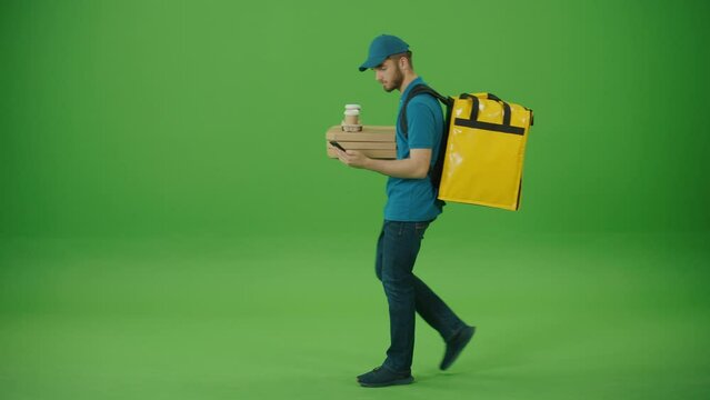 Green Screen Delivery Man in Yellow Uniform With Thermal Backpack Brings Pizza Boxes, Coffee. Deliveryman Worker Deliver Online Order Client. Courier on the Way to Deliver Order to Client