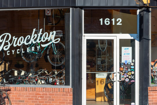 exterior building facade display window entrance and sign of Brockton Cyclery, a bicycle shop, located at 1612 Dundas Street West in Toronto, Canada