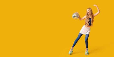 Dancing young woman in vintage roller skates and with disco ball on yellow background with space...