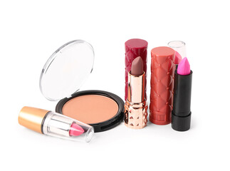 Set of different lipsticks and powder on white background