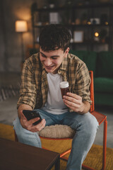 One man hold medicine drugs bottle pills read label on mobile phone