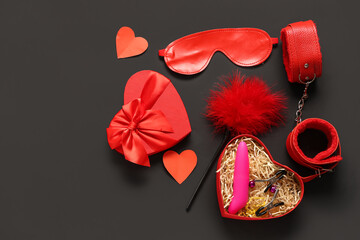 Composition with gift box and sex toys on dark background. Valentine's Day celebration