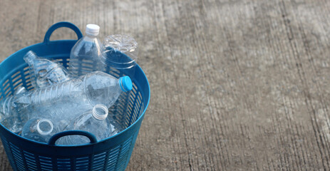 Empty drink bottles in blue plastic basket