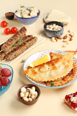 Traditional Eastern dishes on beige background, closeup. Ramadan celebration