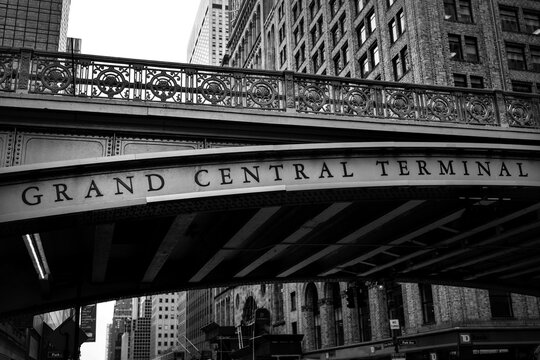 New York, USA - June 23 2023 : Black and white close up detail of the writing 'grand central terminal' on the bridge approaching the famous metro and train station in Manhattan 