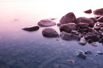 Stones in still ocean water