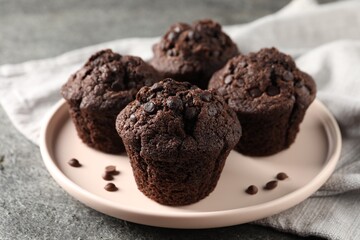 Fototapeta na wymiar Delicious fresh chocolate muffins on grey table, closeup