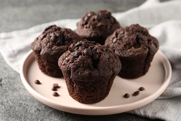  Delicious fresh chocolate muffins on grey table, closeup © New Africa