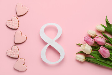 Figure 8 made of paper with tulip flowers and cookies on pink background. International Women's Day celebration