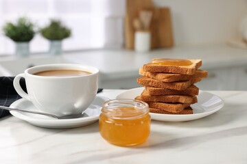 Breakfast served in kitchen. Fresh toasts, coffee and honey on white marble table
