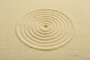 Zen rock garden. Circle pattern on beige sand