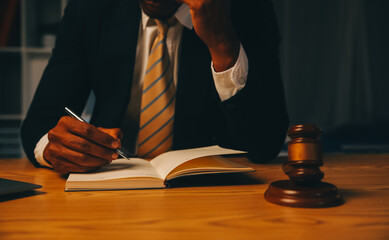 Judge gavel with Justice lawyers having team meeting at law firm background. Concepts of Law and...