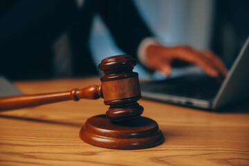 Judge gavel with Justice lawyers having team meeting at law firm background. Concepts of Law and...