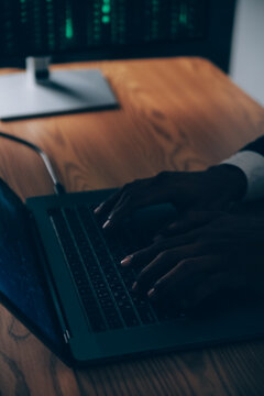 Hacker code in laptop. Cyber security, privacy or hack threat. Coder or programmer writing virus software, malware, internet attack or developing digital design. Green web data in computer screen.