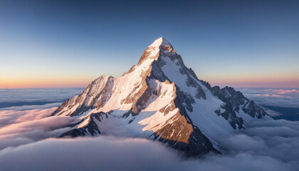 Aerial View of Mountain Peak at Sunset Above Clouds