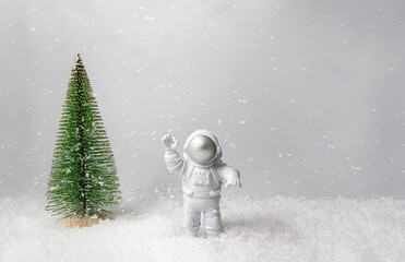 Astronaut and Christmas tree in the background. Concept of celebrating the New Year. Selective...