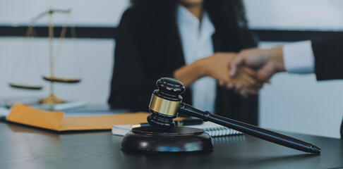 Judge gavel with Justice lawyers having team meeting at law firm background. Concepts of Law and Legal services.