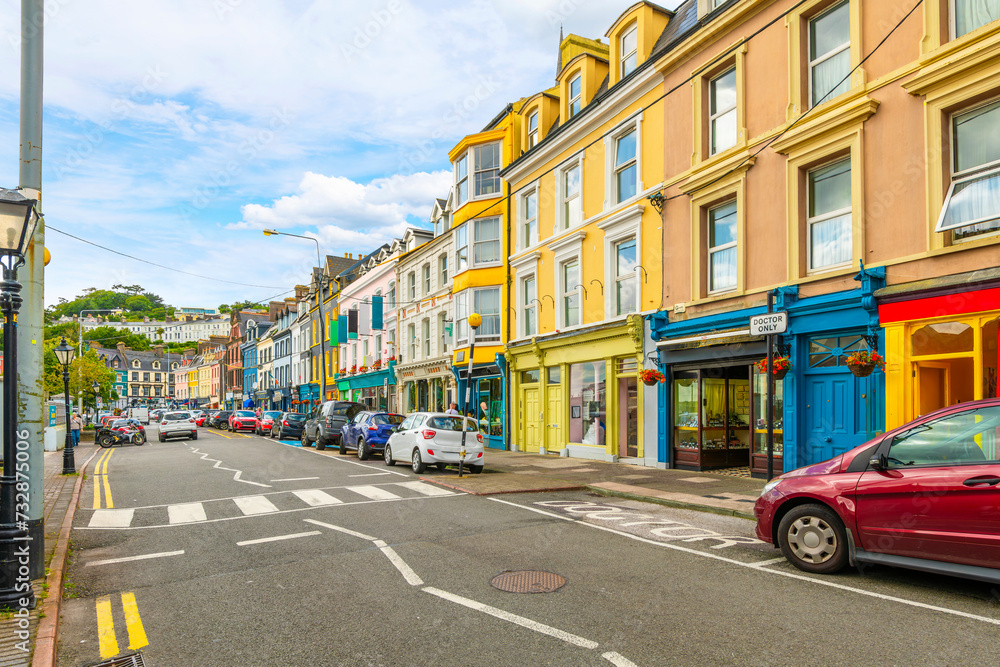 Wall mural the main street of cafes, pubs and shops along the seaside promenade at cobh, county cork, ireland.