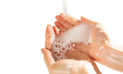 Fototapeta premium cropped view of female hands in soap foam isolated on beige