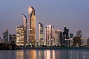Fototapeta na wymiar Abu Dhabi Seascape with skyscrapers in the background at evening