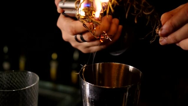 bartender burning rosemary with butane torch rosemary-smoked negroni barman making cocktail video