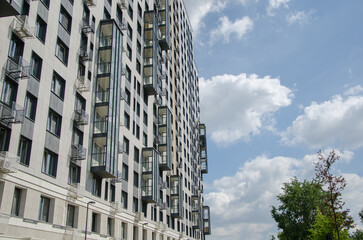 Fototapeta premium City high-rise buildings against the blue sky. Office apartments.