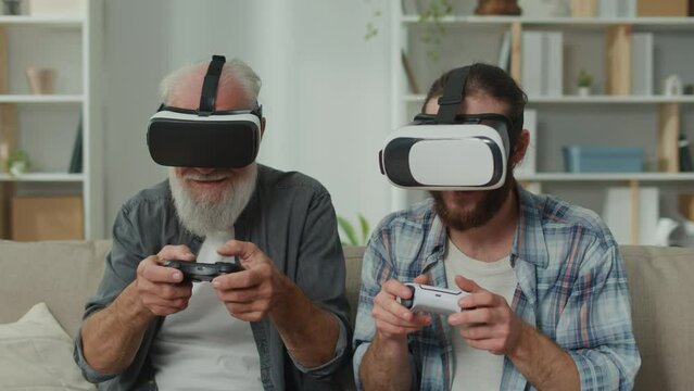 Young adult and senior immerse in VR gaming, exchanging experiences between generations through virtual reality, leveraging cutting-edge tech for entertainment, family teaching and understanding in VR
